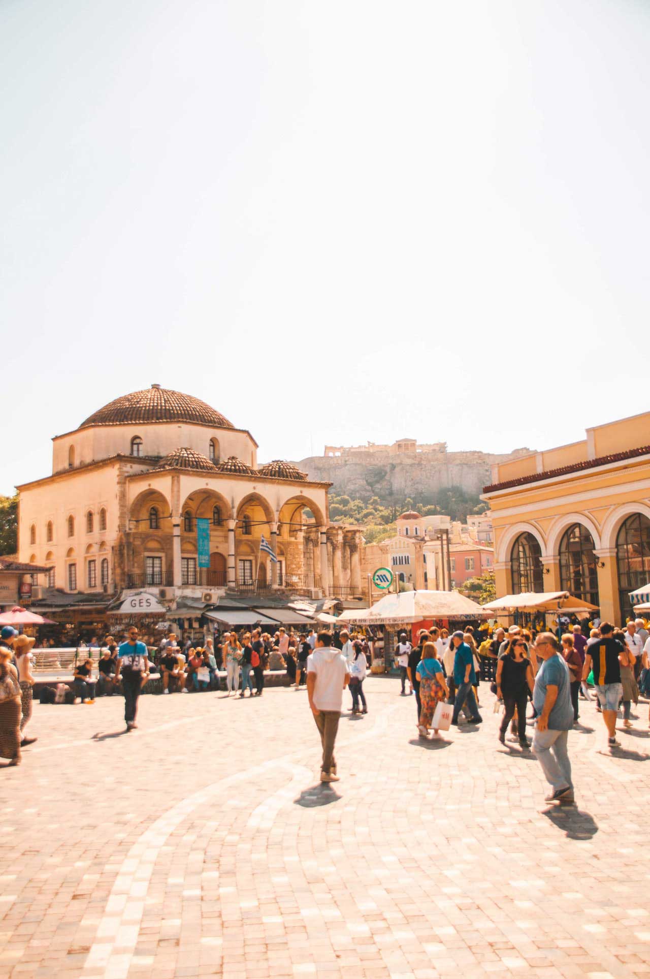 city center of Athens Greece in monastiraki with people walking around the plaza with around the world top 5