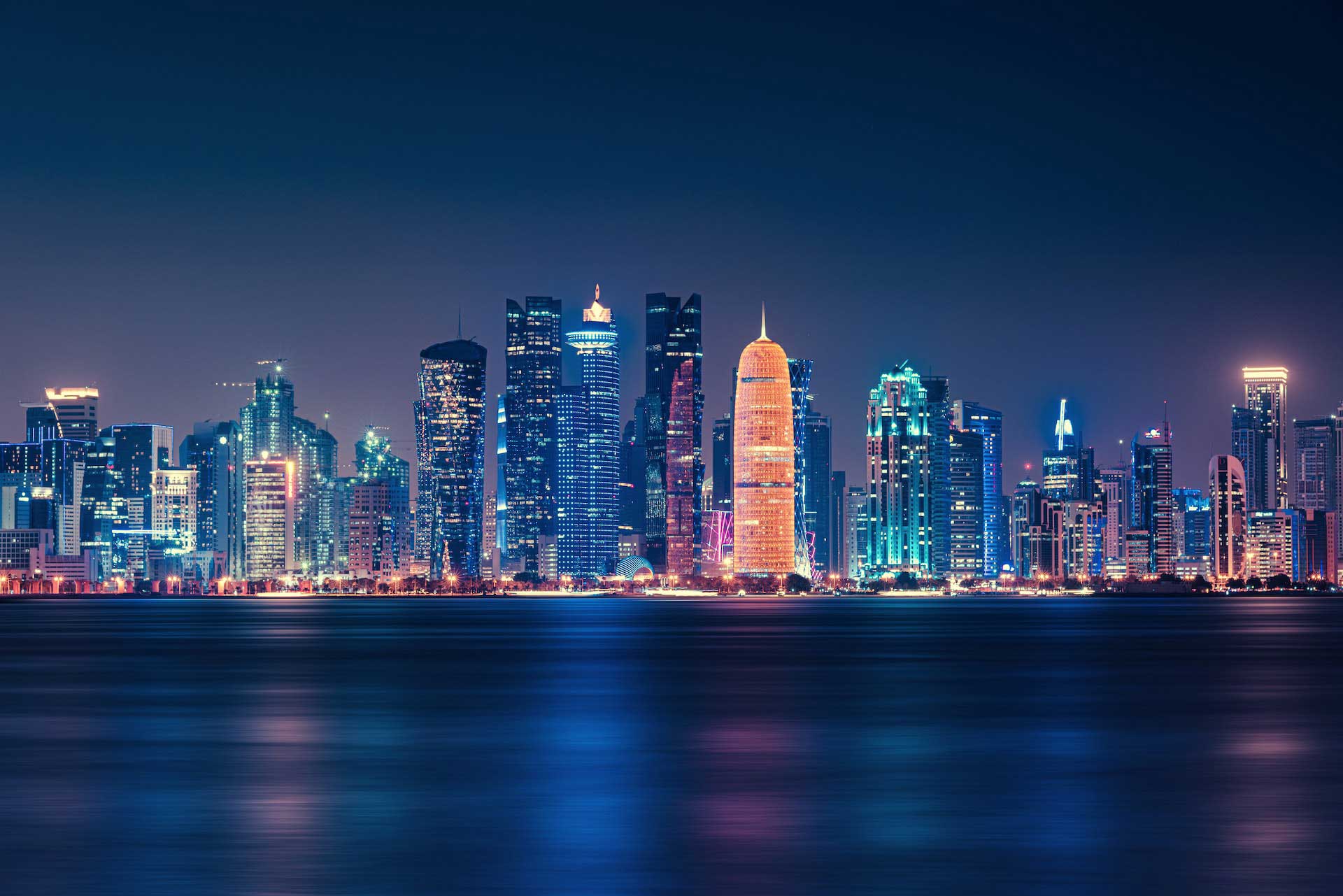 city night tall buildings in doha overlooking the water around the world top 5