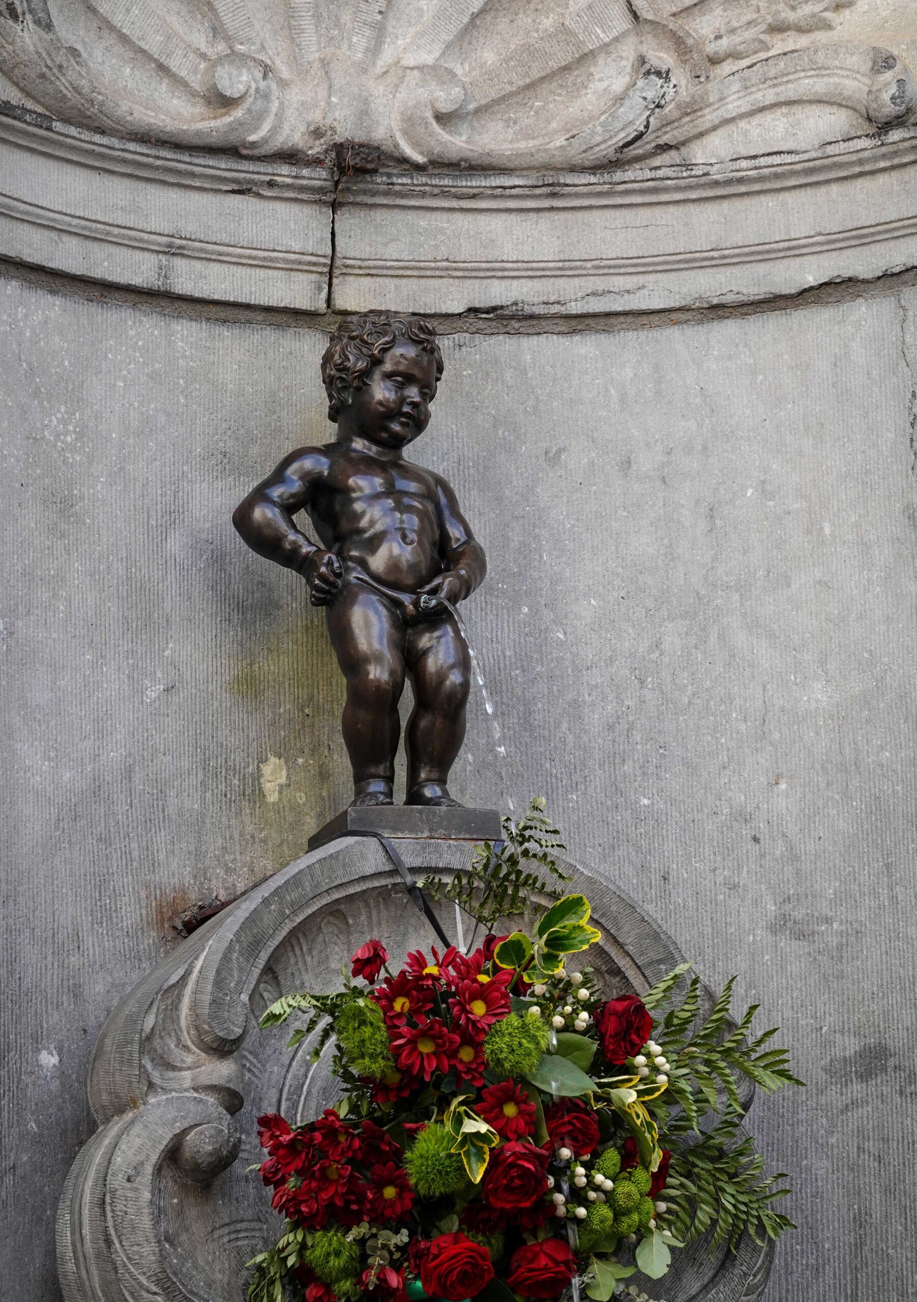 Small manneken statue in brussels belgium of a boy, popular tourist attraction in brussels for top 5 around the world places.