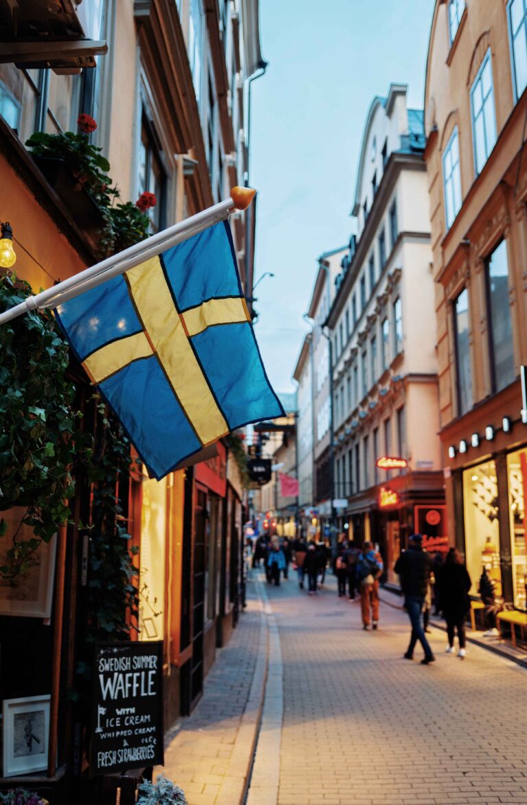 Cafe street in stockholm sweden with swedish flag that is blue and yellow around the world top 5