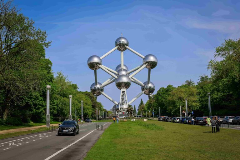 silver balls that are the atomium in belgium with trees along the side