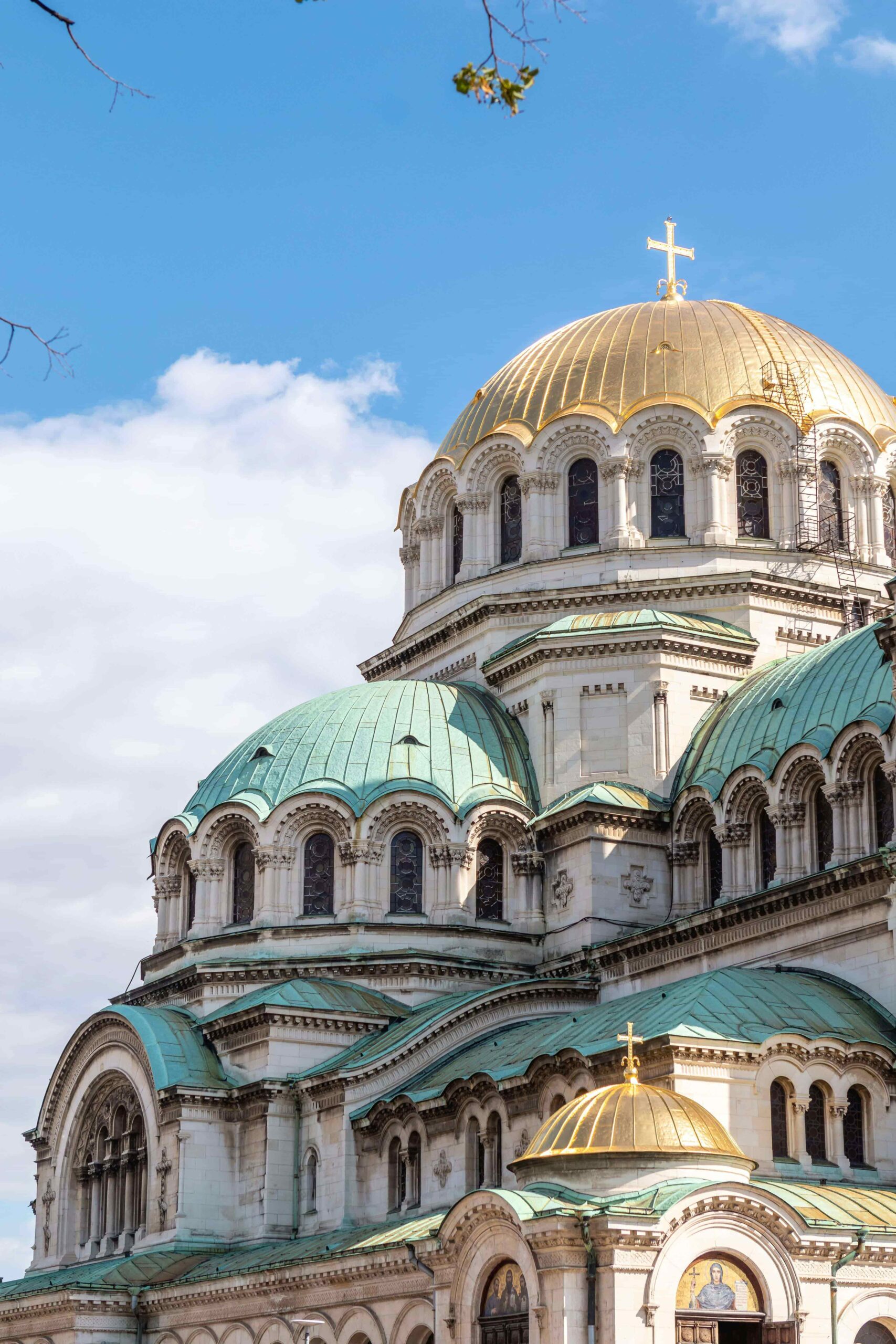 dome circular shaped church in bulgaria, gold dome and smaller blue dome with clear blue skies