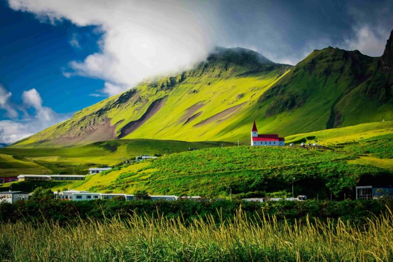 big green mountains in iceland with blue skies and green pastures